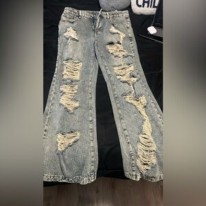 Distressed blue and navy jeans 
They’re a size large and never been worn.